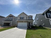 Newly constructed two-story home with a neutral color scheme, two-car garage, and concrete driveway at 753 Swim Cave Ln, Wendell, NC 27591
