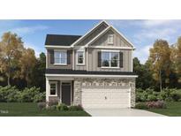 Charming two-story home showcases stone accents, a two-car garage, and meticulous landscaping at 753 Swim Cave Ln, Wendell, NC 27591