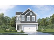 Two-story home showcasing a modern exterior, a two-car garage, and manicured landscaping at 757 Swim Cave Ln, Wendell, NC 27591