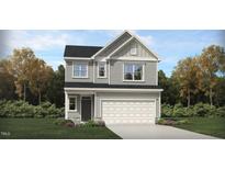 Charming two-story home with gray siding, a two-car garage, and a landscaped front yard at 100 Fishing Pier Way, Lillington, NC 27546