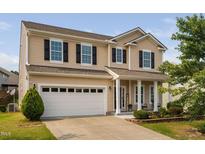 Charming two-story home features a welcoming front porch and a two-car garage at 105 Putters Ct, Durham, NC 27703