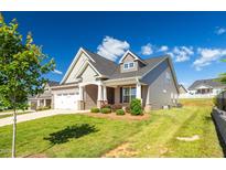 Charming two-story home with manicured lawn, neutral siding, and a welcoming two-car garage at 1085 Lobdale Ct, Burlington, NC 27215