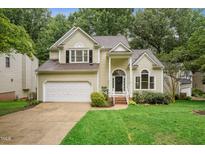 Charming two-story home featuring a well-manicured lawn and attached two car garage at 111 Catherwood Pl, Cary, NC 27518