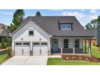 Charming home with a two-car garage, inviting front porch, and lovely blue front door at 112 Cultivator Ct, Angier, NC 27501