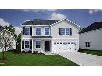 Charming two-story home with black shutters, a well-manicured lawn, and an attached two-car garage at 120 Cordoba Dr, Franklinton, NC 27525