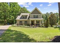 Charming two-story home with landscaped front yard and classic architectural details at 12636 Old Creedmoor Rd, Raleigh, NC 27613