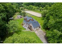 Expansive estate featuring a home, horse paddock, barn and a tranquil setting surrounded by lush greenery at 12823 Summerwind Trl, Rougemont, NC 27572