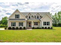 Charming two-story home featuring a manicured lawn and inviting front porch at 1779 Walter Grissom Rd, Kittrell, NC 27544