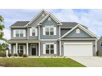 Charming two-story home with gray siding, white trim, and a well-manicured lawn, showing great curb appeal at 225 Rosewood Ln, Youngsville, NC 27596