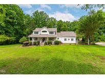 Charming two-story home with a manicured lawn and a welcoming front porch at 228 Birch Creek Dr, Fuquay Varina, NC 27526