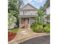 Charming two-story home featuring a welcoming front porch and well-maintained landscaping at 2801B Cannada Ave, Durham, NC 27704