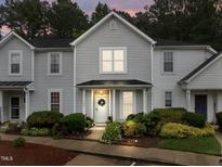 Charming two-story townhome with landscaped front yard, beautiful day time lighting, and inviting entrance at 3021 White Cloud Cir, Apex, NC 27502