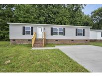 Charming single-story home with gray siding, brick foundation, and a well-manicured lawn at 332 Eastfield Dr, Rocky Mount, NC 27801