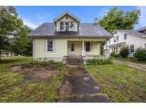 Charming two-story home featuring a classic design, inviting front porch and gray shingled roof at 421 E Morehead St, Burlington, NC 27215