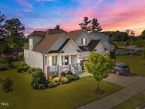 Charming two-story home featuring a covered front porch, well-maintained lawn, and beautiful landscaping at 461 Cedar Pond Ct, Knightdale, NC 27545