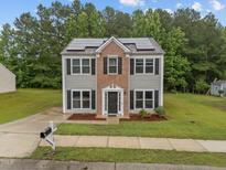 Charming two-story home with solar panels, well-maintained lawn, and inviting curb appeal at 612 Quartz Dr, Durham, NC 27703
