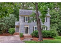 Charming two-story home with gray siding, dark shutters, and mature landscaping at 7 Hitching Rack Ct, Durham, NC 27713