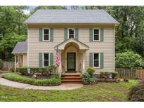 Charming two-story home with a well-manicured front yard and an American flag at 7520 Milestone Ct, Raleigh, NC 27615