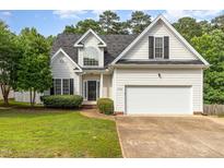 Charming home with a two-car garage, manicured lawn, and classic architectural details at 7936 Milltrace, Raleigh, NC 27615