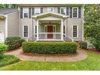 Inviting front porch with a walkway, white railing, and lush landscaping that adds to the home's curb appeal at 106 Ridgepath Way, Cary, NC 27511