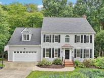 Charming two-story home with a well-manicured lawn and a two-car garage at 113 Bergeron Way, Cary, NC 27519
