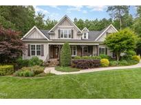 Charming craftsman home with stone accents, a welcoming front porch, and lush landscaping at 114 Margaret Mann Way, Pittsboro, NC 27312