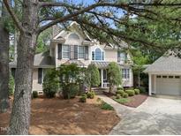 Charming two-story traditional home featuring manicured landscaping and a detached garage at 1300 Heritage Club Ave, Wake Forest, NC 27587