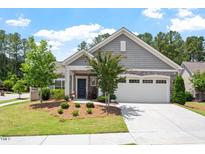 Charming single-story home featuring a manicured lawn, stone accents, and a two-car garage at 1357 Prevenient Dr, Wake Forest, NC 27587