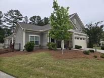 Charming home showcasing meticulous landscaping and a stone-accented facade and a two car garage at 1357 Prevenient Dr, Wake Forest, NC 27587