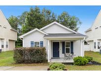 Charming single-story home with blue shutters and a cozy front porch seating area at 1506 Golden Bell Dr, Raleigh, NC 27610