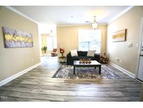 Inviting living room featuring hardwood floors and neutral paint colors at 1912 Parkside Village Dr, Clayton, NC 27520