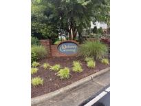 Delaney Crossing community sign surrounded by lovely landscaping near sidewalk at 2221 Delaney Dr # 112, Burlington, NC 27215