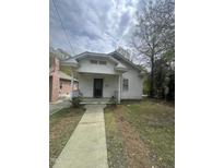 Charming white home with a covered front porch, complemented by a simple, concrete walkway leading to the entrance at 2511 Chapel Hill Rd, Durham, NC 27707