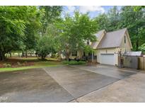 Charming home with a two-car garage and long driveway surrounded by lush trees at 275 Eagle Stone Rdg, Youngsville, NC 27596