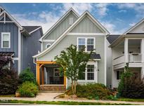 Charming two-story home featuring a welcoming front porch and beautiful landscaping at 290 Quarter Gate Trce, Chapel Hill, NC 27516