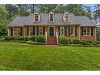 Charming brick home featuring a well-manicured lawn and dormer windows at 3919 Wentworth Dr, Durham, NC 27707
