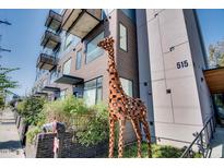 Contemporary building with a metal giraffe sculpture in front and modern architectural elements at 515 N Mangum St # 41, Durham, NC 27701