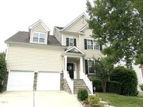 Charming two-story home featuring a welcoming front porch, two-car garage and well-maintained landscaping at 609 Redford Place Dr, Rolesville, NC 27571