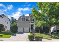 Charming two-story home featuring a two-car garage, manicured lawn, and inviting front porch, perfect for suburban living at 609 Redford Place Dr, Rolesville, NC 27571