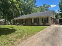 Charming single-story home featuring a well-maintained front yard and a long driveway at 708 Old Barn Ave, Durham, NC 27704