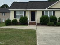 Charming one-story home with a well-maintained lawn and neatly trimmed shrubs at 78 Ariel Street, Lillington, NC 27546