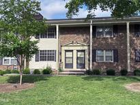 Charming brick townhome with a well-maintained lawn and inviting front entrance at 1002 Willow Drive Dr # 37, Chapel Hill, NC 27514