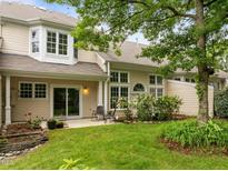Charming backyard featuring a patio, lush green lawn, and manicured garden beds perfect for relaxation at 103 Lake Tillery Dr, Cary, NC 27519