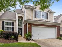 Charming townhome featuring a two-car garage and well-maintained landscaping at 103 Lake Tillery Dr, Cary, NC 27519