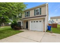 Charming two-story home featuring neutral siding, green shutters, a one-car garage and a well-manicured lawn at 1310 Silver Dr, Mebane, NC 27302