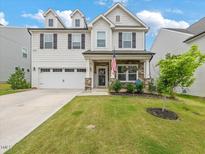 Charming two-story home with a well-manicured lawn and inviting front porch at 146 Bent Willow Dr, Clayton, NC 27527