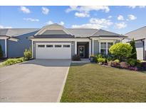Charming single-story home featuring a two-car garage, well-maintained lawn and colorful landscaping at 1533 Santa Lucia St, Wake Forest, NC 27587