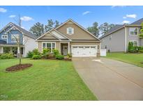 Charming single-Gathering home with a two-car garage and a well-manicured front lawn at 247 Axis Deer Ln, Garner, NC 27529