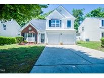 Charming two-story home featuring a well-manicured lawn and a two-car garage at 3016 Hayling Dr, Raleigh, NC 27610