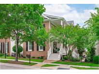 Charming two-story brick home with white trim, black shutters and a well-manicured lawn at 321 Commons Walk Cir, Cary, NC 27519